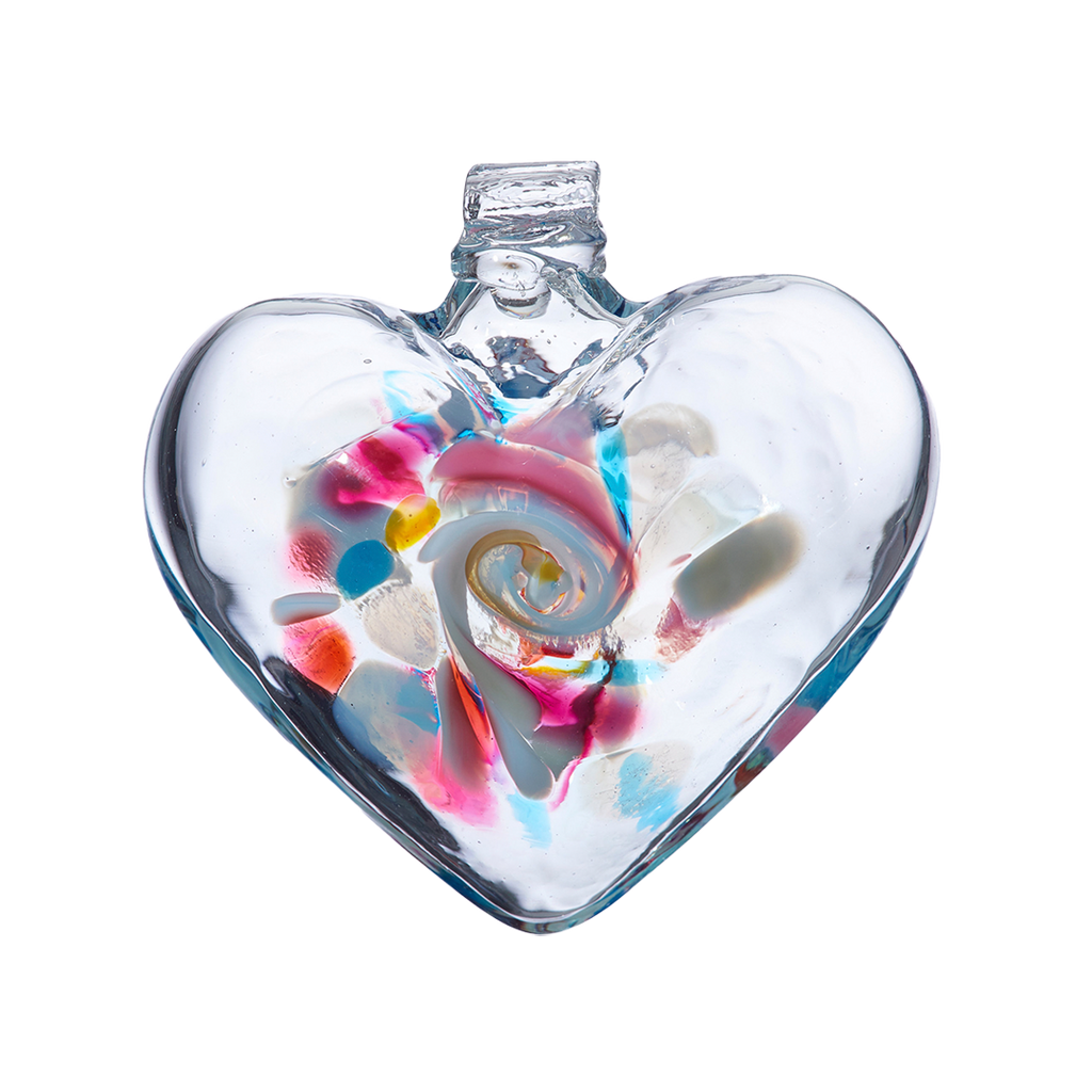 Clear glass heart with blue, pink, yellow and opaque white glass swirled in the centre on a transparent background.