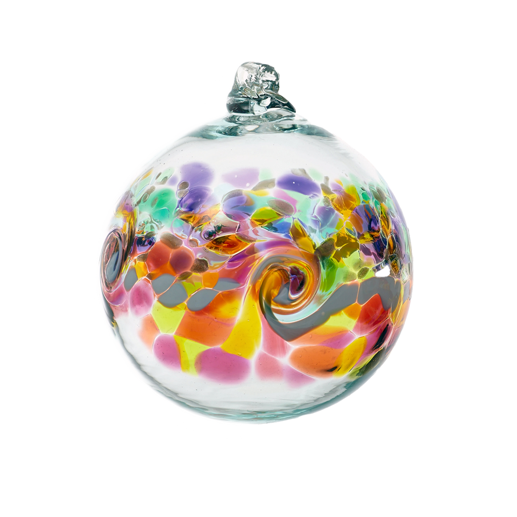 Glass orb with a band of colour around the middle. Purple, green and amber on top, a white band of opaque glass swirled in the middle and red, yellow, pink and orange glass below on a transparent background