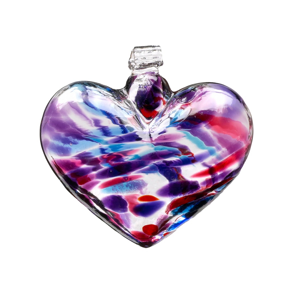 Glass heart with purple, pink, blue and red mosaiced around the entire surface on a transparent background.