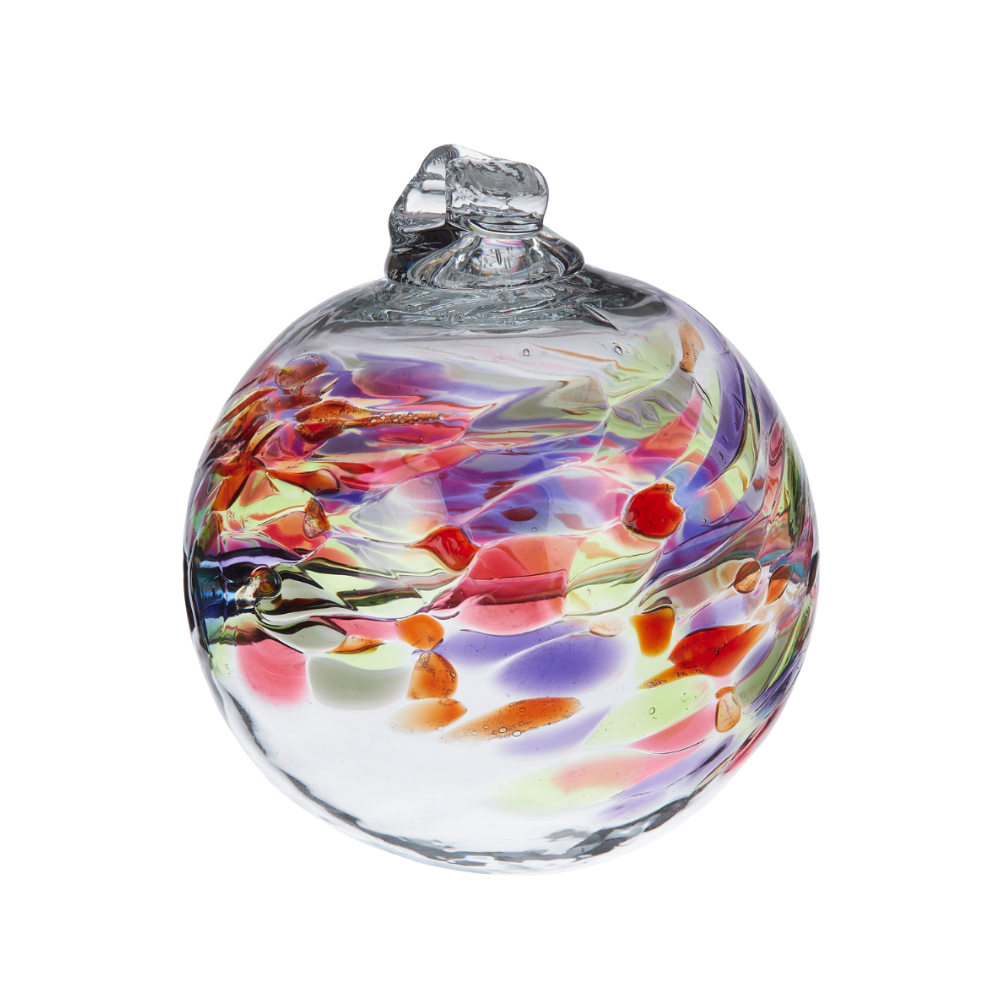 Glass orb with purple, pink, red, green and grey coloured glass around the middle and horizontal webbing on a transparent background.
