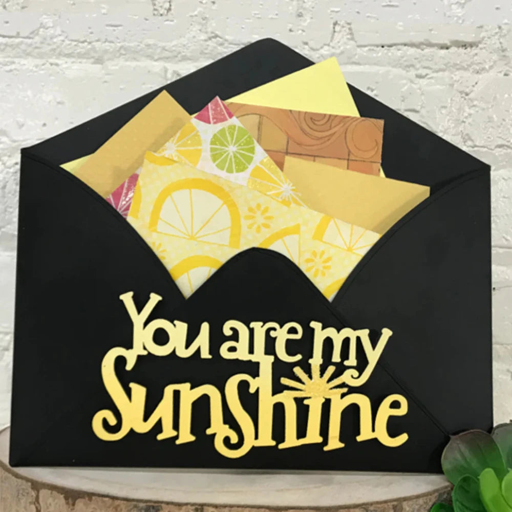Black Envelope Wall Display with "You are my Sunshine" magnet, filled with letters. 