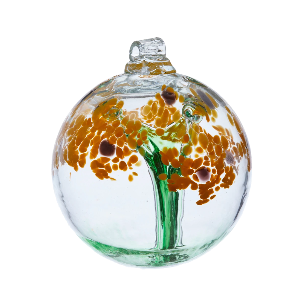 Clear glass orb with a green stem pulled from bottom to top to a canopy of yellow opaque glass blossoms and brown centres on a transparent background.